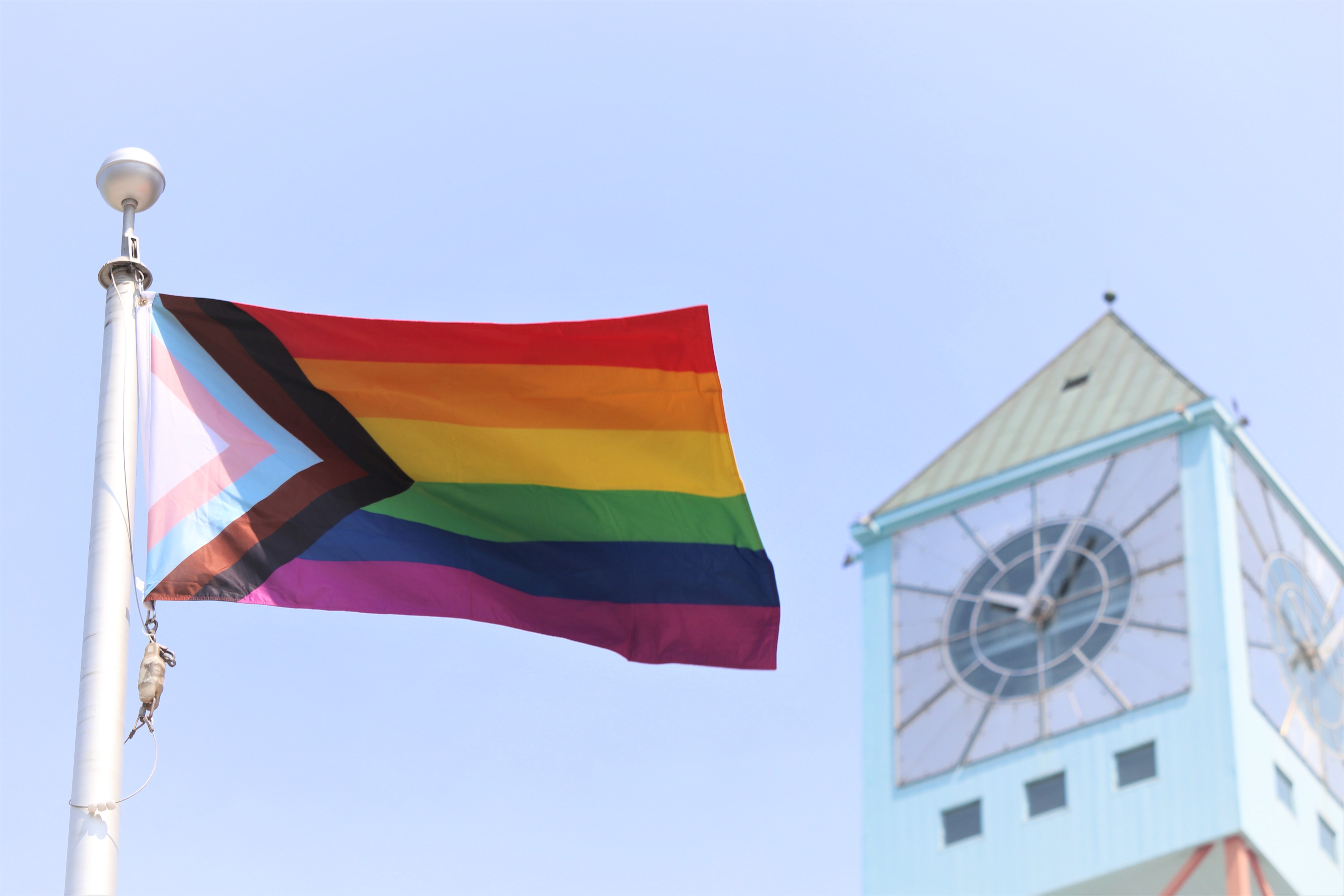 Pride flag in front of the Civic Centre clock tower.